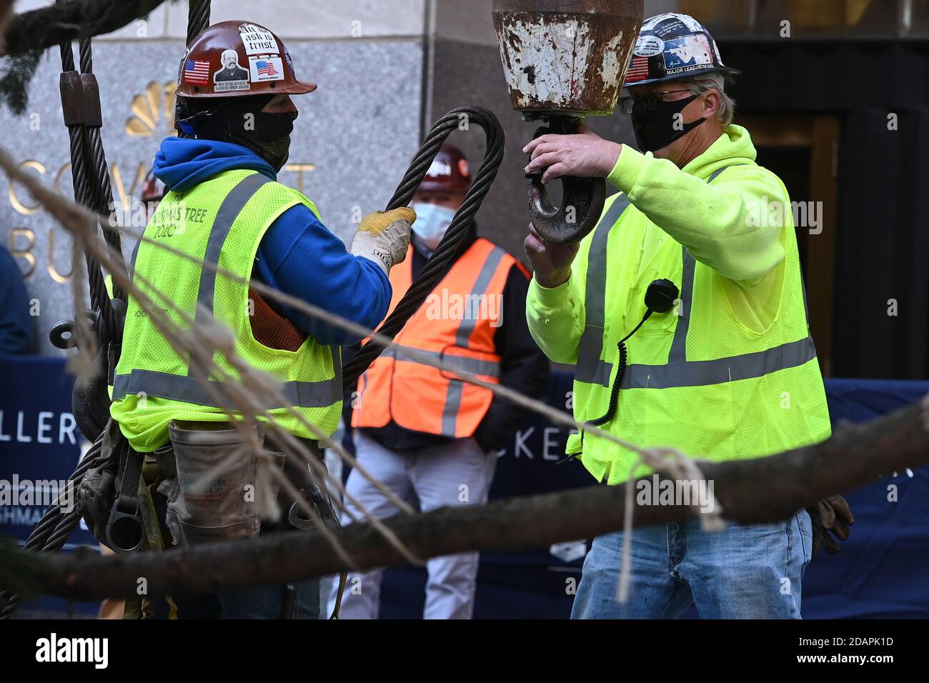 New York City, USA. 14th Nov, 2020. Riggers attache a crane cable to a ...