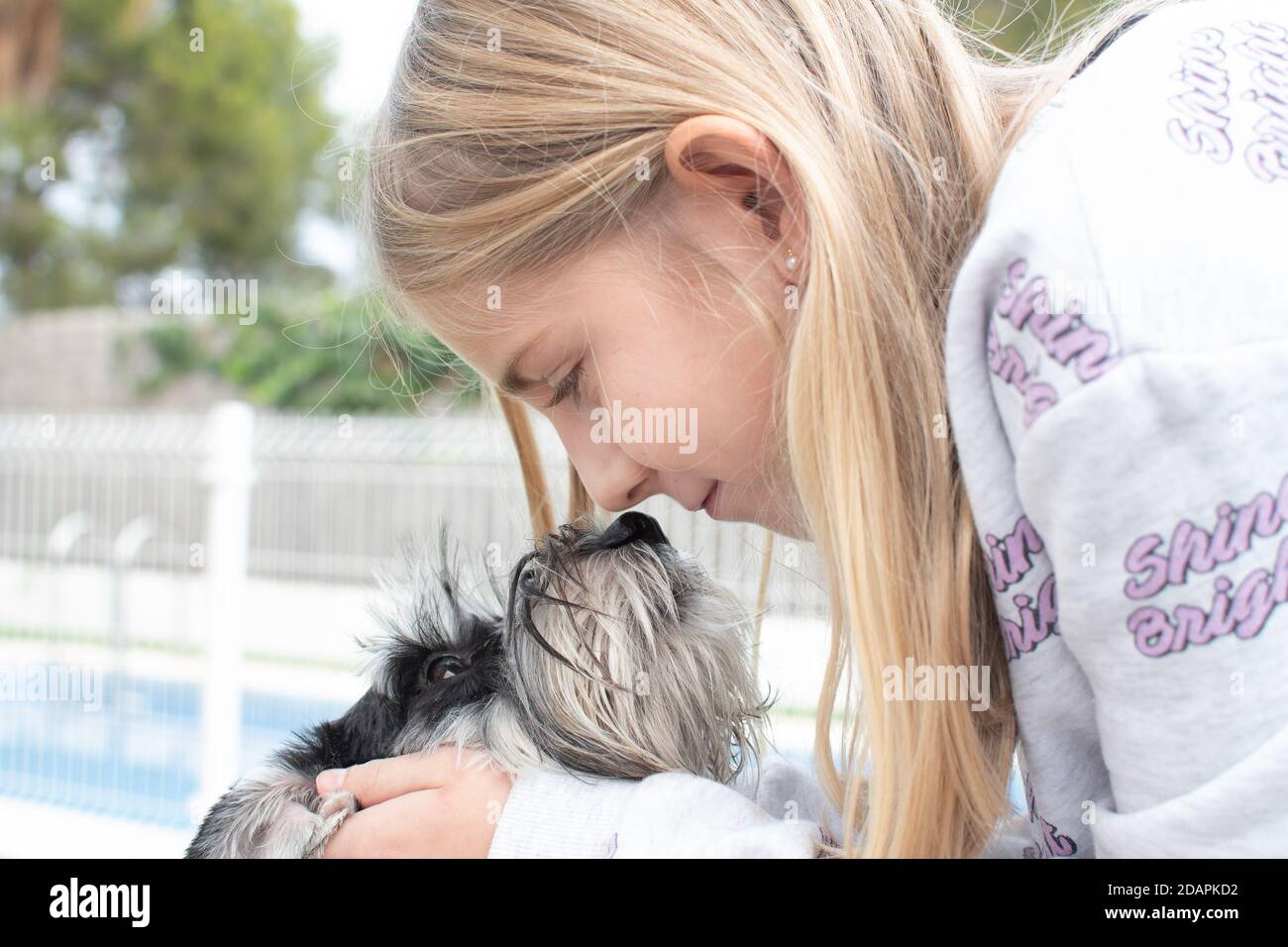 A child with a dog in nature. girl playing with a dog on green grass at ...