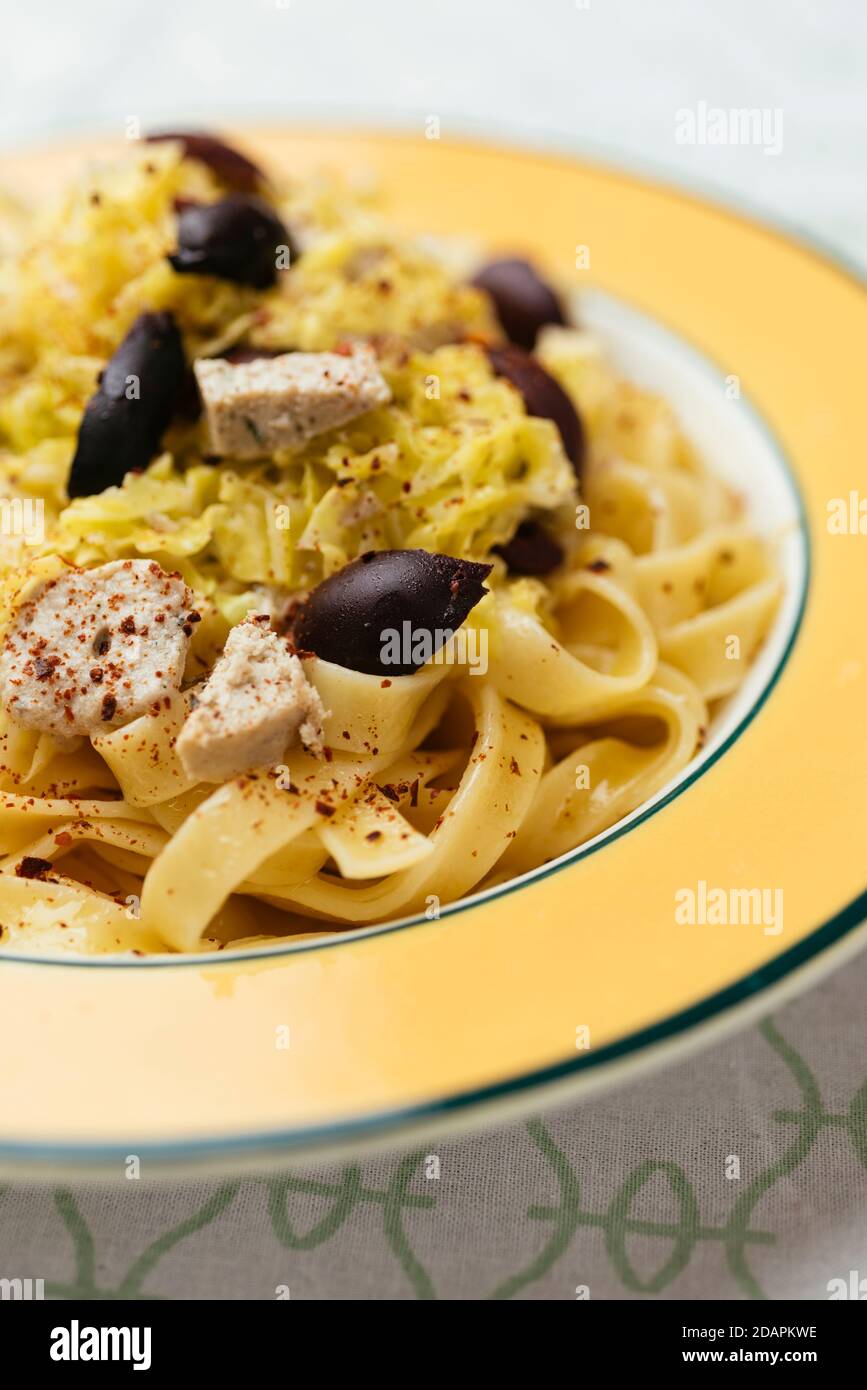 Pasta with Savoy Cabbage, Olives and Vegan Feta Stock Photo
