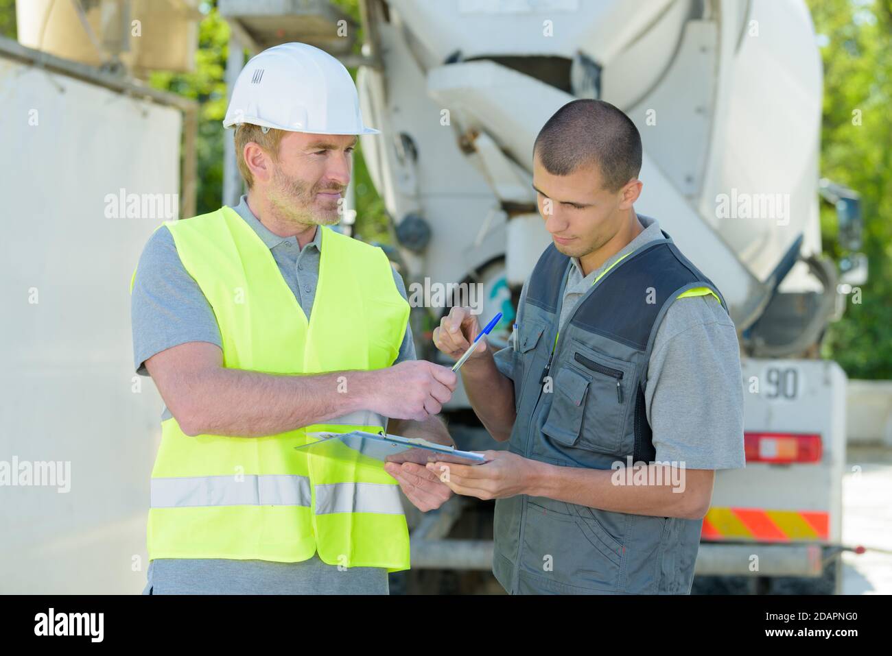 cement mixer transportation driver asking for signature Stock Photo Alamy
