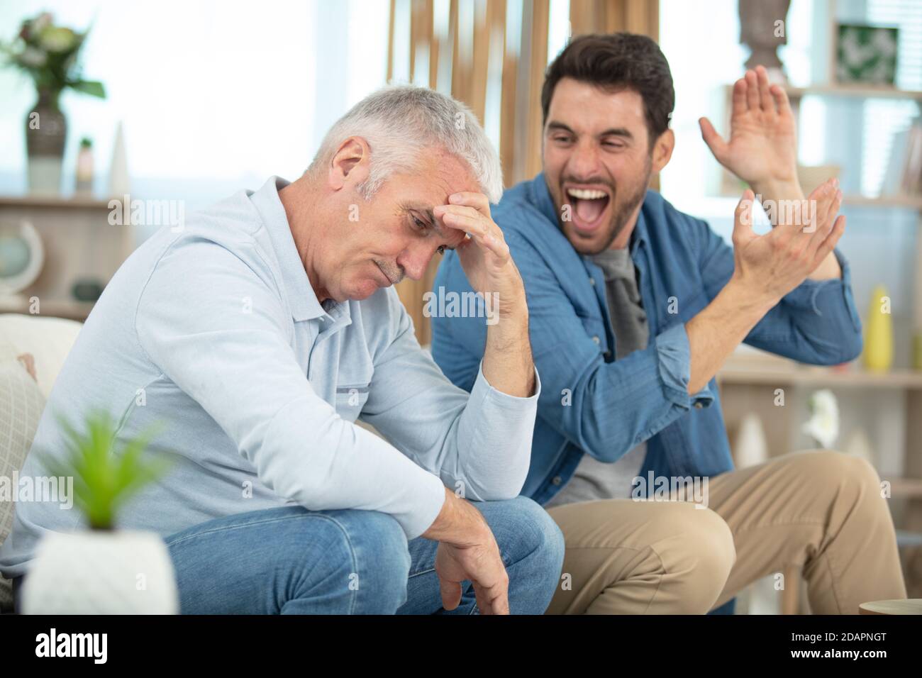 domestic quarrel between mature father and adult son Stock Photo