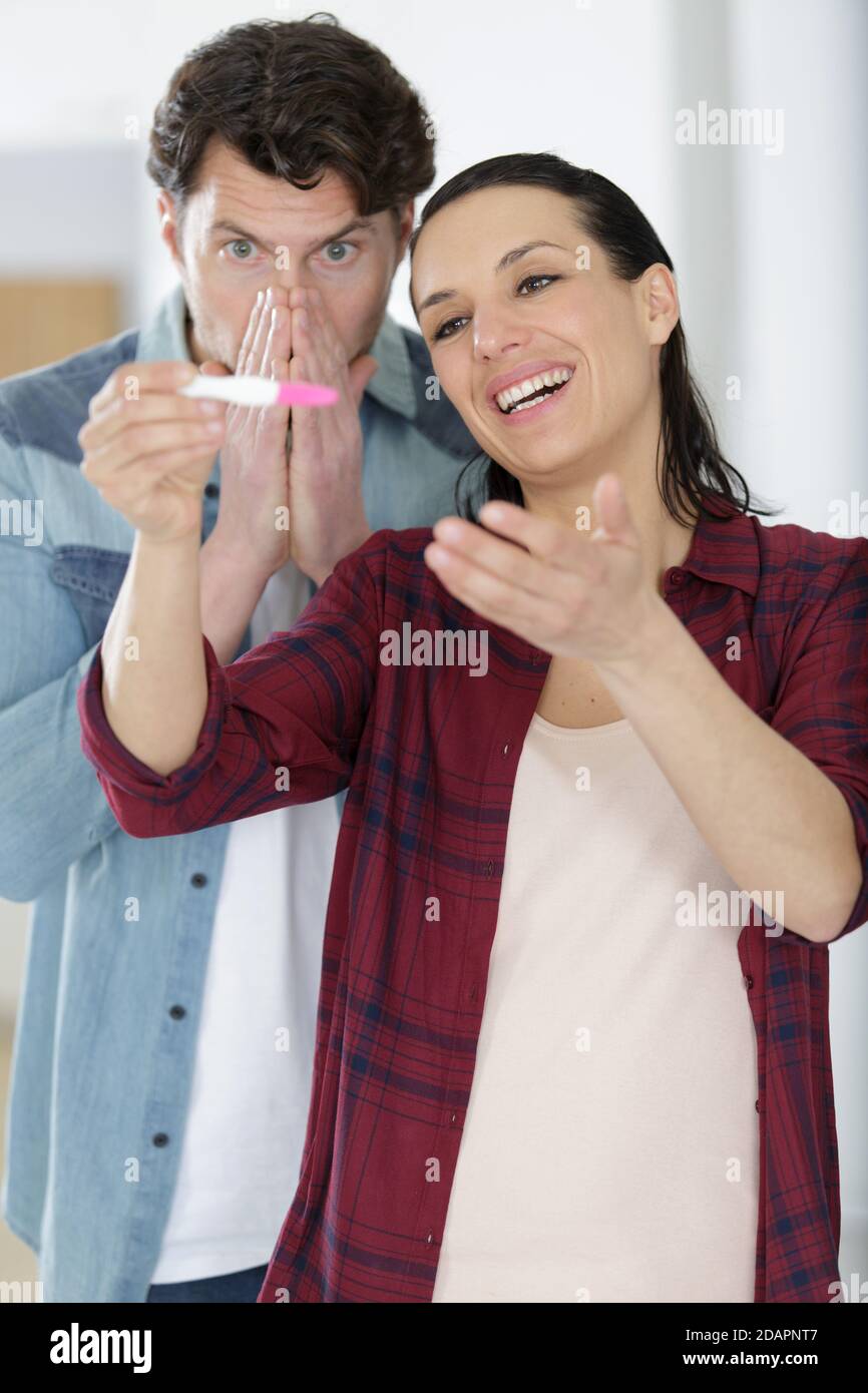 mixed emotions from couple looking at pregnancy test Stock Photo Alamy
