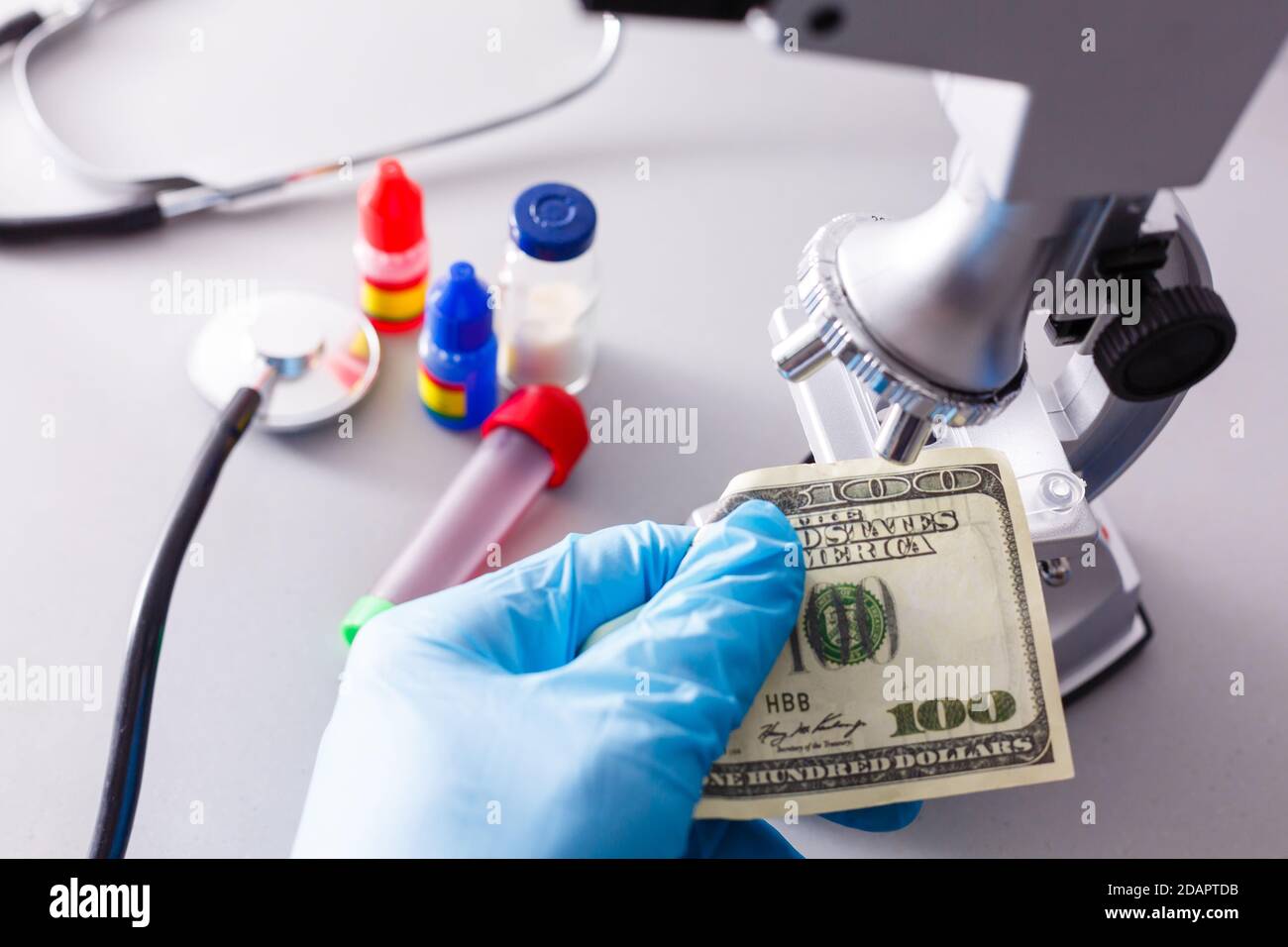 Microscope examining dollar strength on a white background Stock Photo