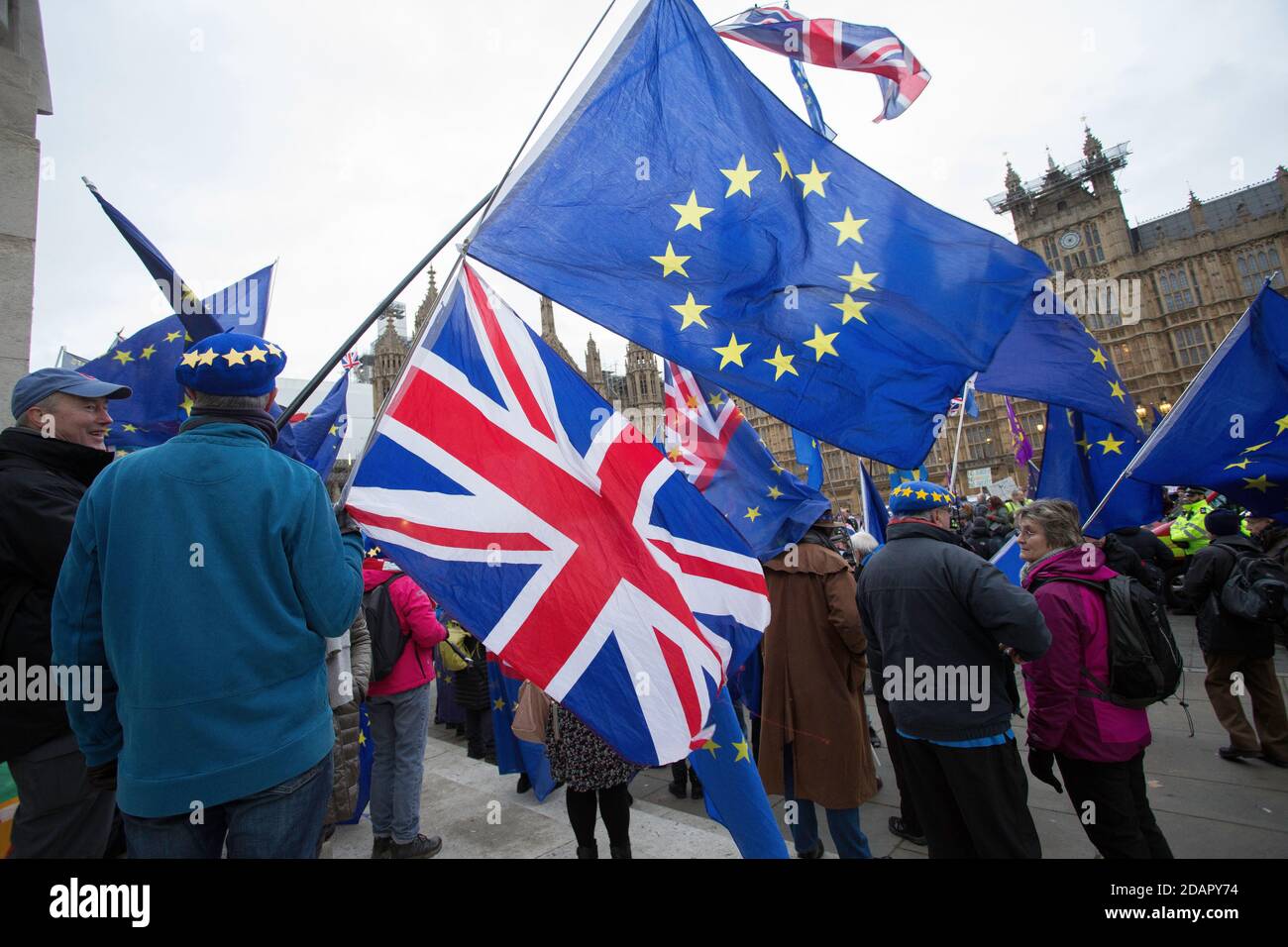 GREAT BRITAIN / England / London /An anti-Brexit demonstrator waves a Union flag and  European Union (EU) flag outside the Houses of Parliament . Stock Photo