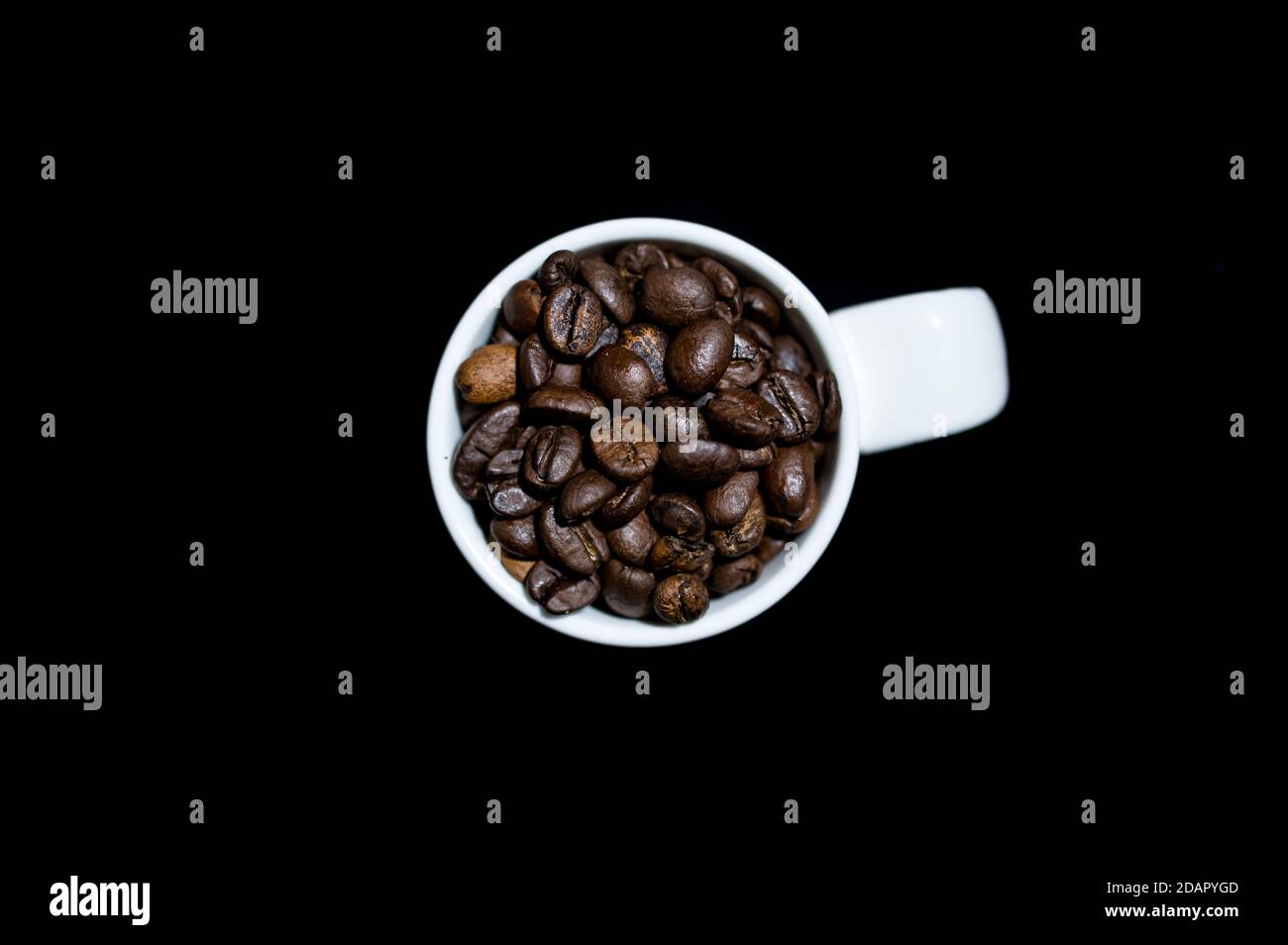 Espresso coffee mug on a black background full of coffee beans Stock Photo