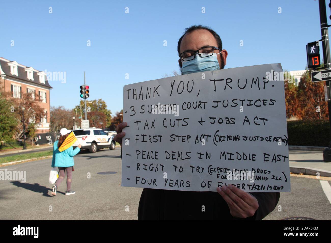 Washington Dc, USA. 14th Nov, 2020. (NEW) Trump and Biden Supporters clash at the Supreme Court in Washington DC. November 14, 2020, Washington DC, Maryland, USA: Trump and Biden supporters clash at the Supreme Court in Washington DC during a TrumpÃ¢â‚¬â„¢s MAGA Million March to show their support for Trump and protest against the Presidential election result which they claim to be fraudulent. There were some Police Officers to provide security between them .Credit : Niyi Fote /Thenews2. Credit: Niyi Fote/TheNEWS2/ZUMA Wire/Alamy Live News Stock Photo