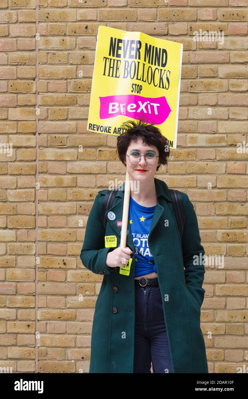 LONDON, UK - A female anti-brexit protester holds a placard during Anti Brexit protest on March 23, 2019 in London. Stock Photo