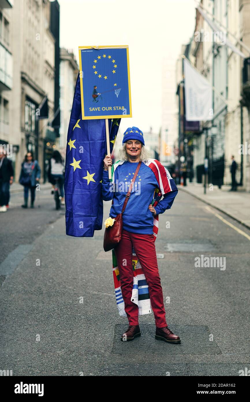 LONDON, UK - A anti-brexit protester holds a 'save our star 'placard during Anti Brexit protest on March 23, 2019 in London. Stock Photo