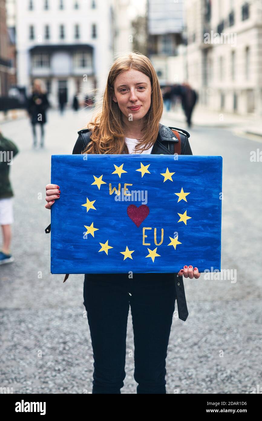 LONDON, UK - A anti-brexit protester holds a 'we love eu'placard during Anti Brexit protest on March 23, 2019 in London. Stock Photo