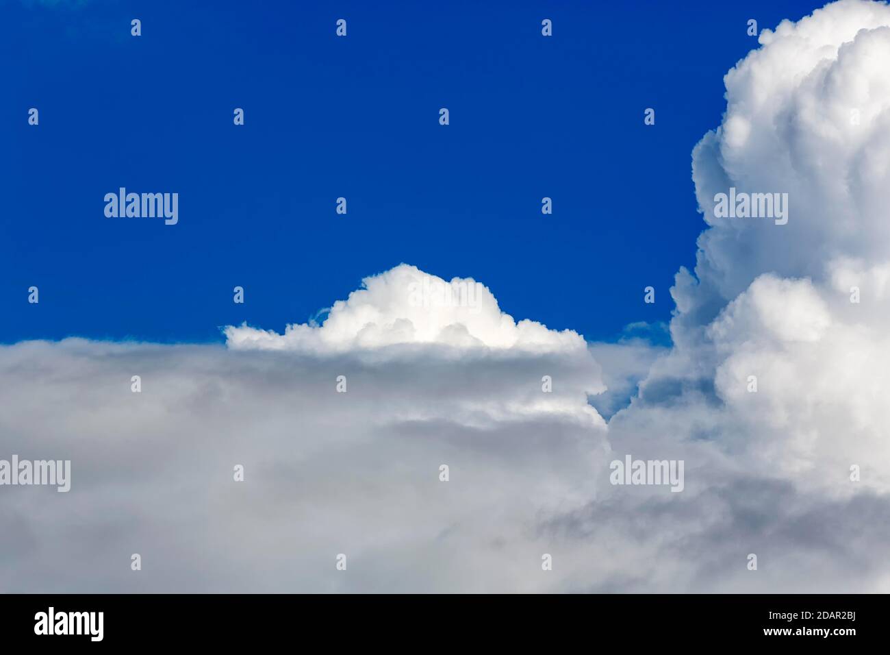 Cloud formation, stratus clouds and cumulus clouds, cumulus clouds in front of a blue sky, background image, North Rhine-Westphalia, Germany Stock Photo