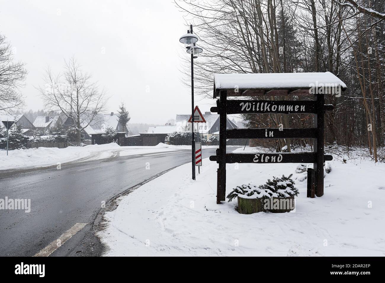 Welcome sign made of wood at the entrance of the village, Welcome to Elend, dreary winter weather, district Elend, Oberharz am Brocken, district Stock Photo