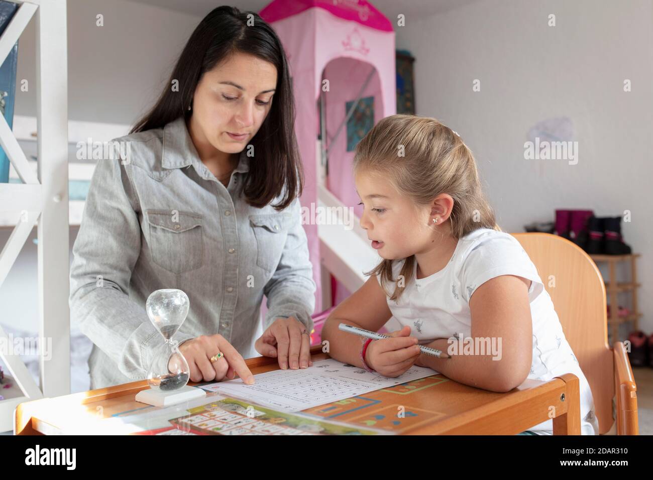 Mother and daughter at homework supervision, home schooling, Schliersee, Bavaria, Germany Stock Photo