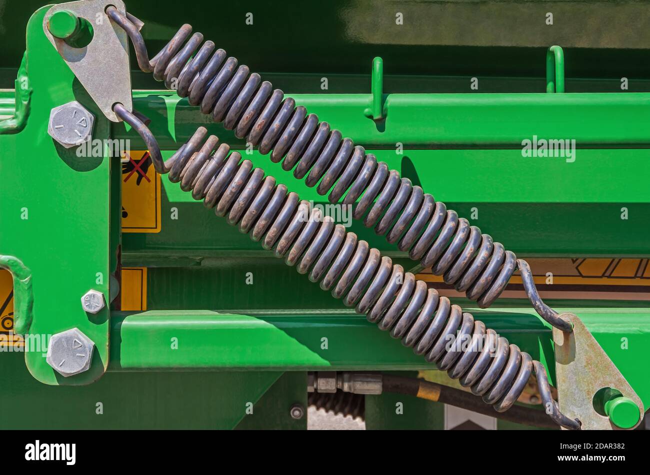 Spring damping system. Double spring shock absorber mounted on mechanical device Stock Photo