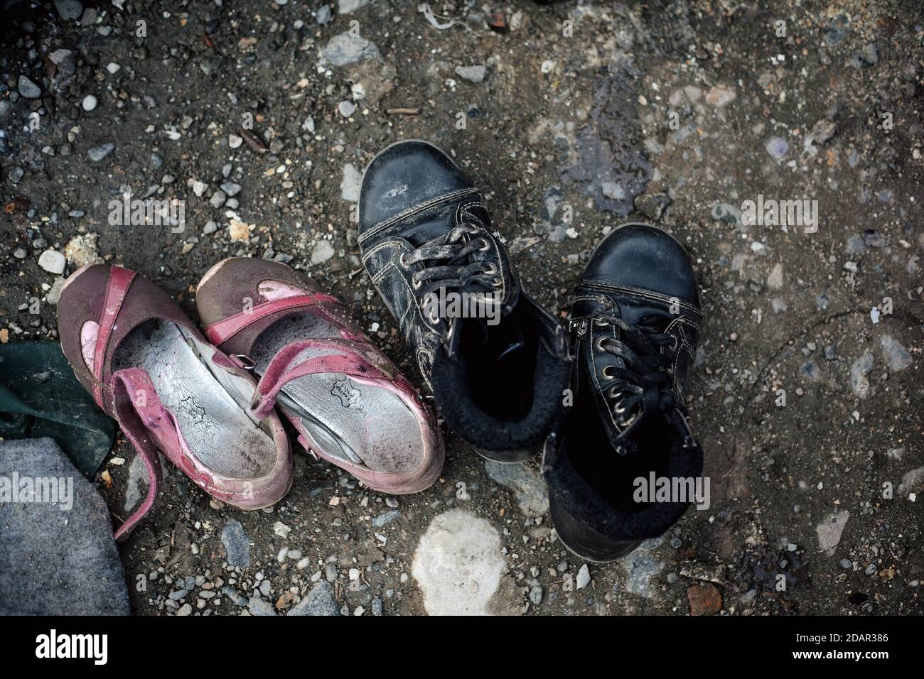 Two pairs of children's shoes, shoes of refugees, camp Idomeni, Greece Stock Photo