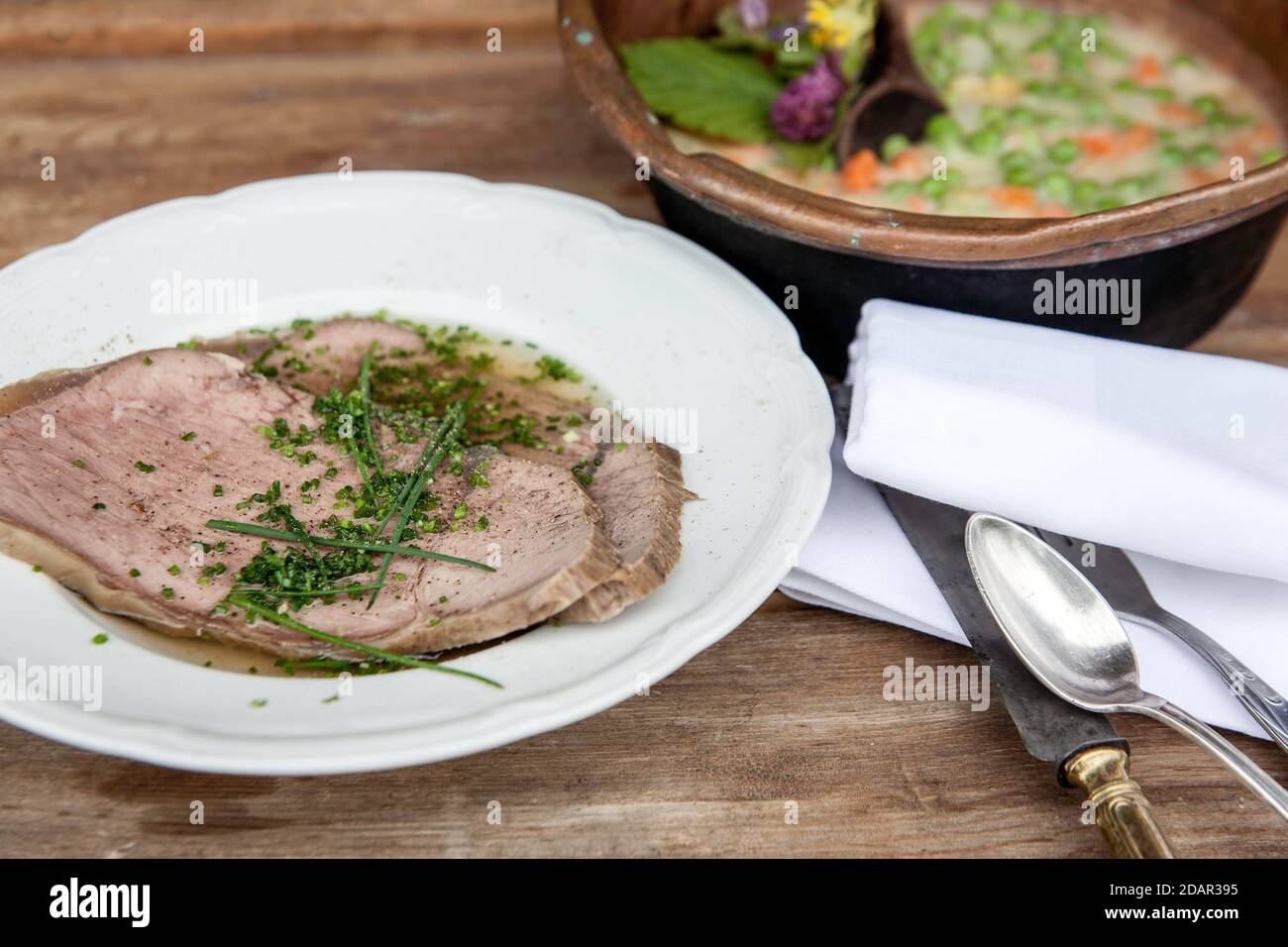 Boiled boiled beef with beef soup and chives, peas and carrots as creamy vegetables, Rauris, Pinzgau, Salzburger Land, Austria Stock Photo