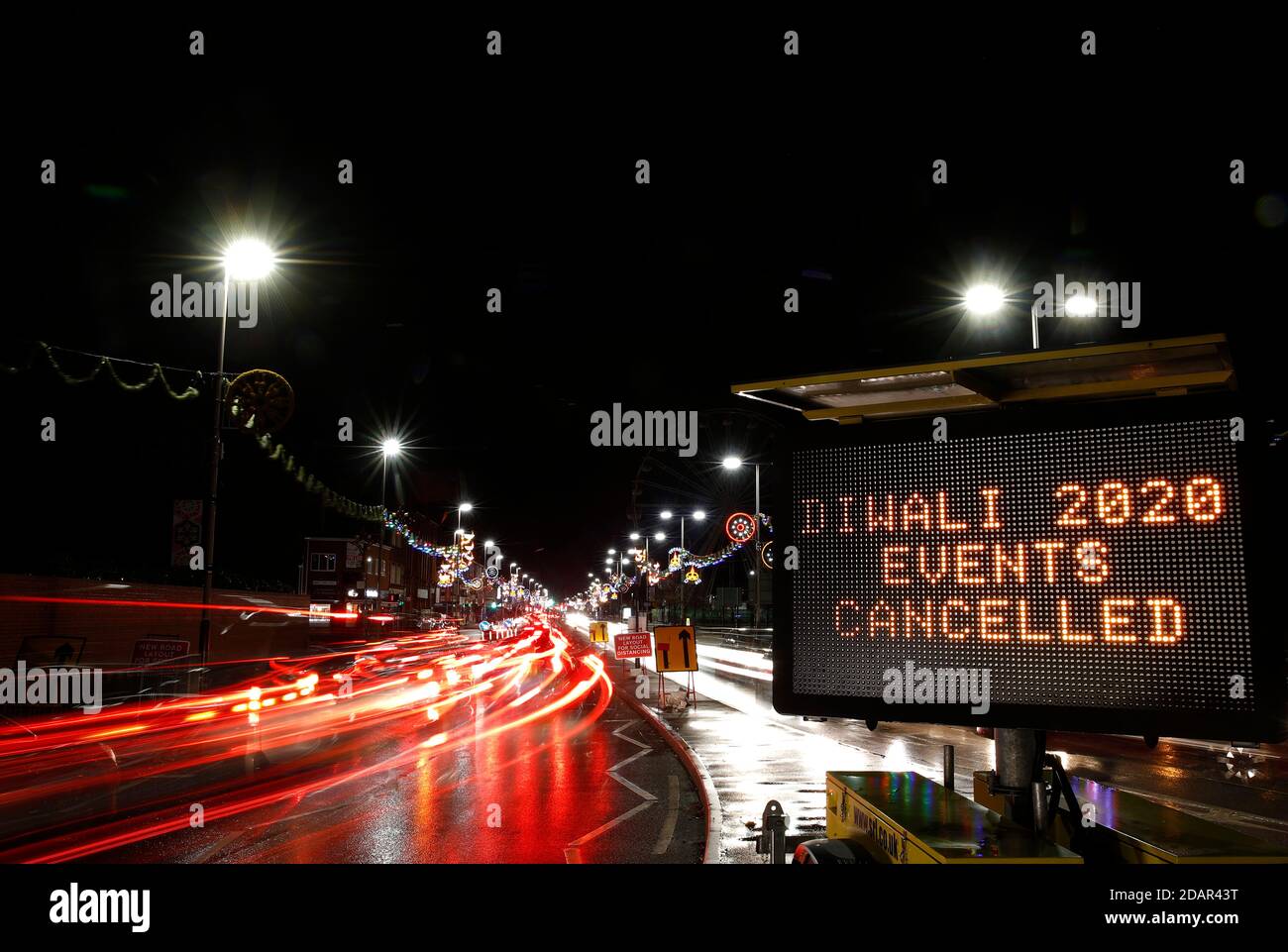 Leicester, Leicestershire, UK. 14th November 2020. Cars stream past a warning sign on the Golden Mile after Covid-19 restrictions meant the usual Diwali day ceremony and celebrations were cancelled this year. Credit Darren Staples/Alamy Live News. Stock Photo