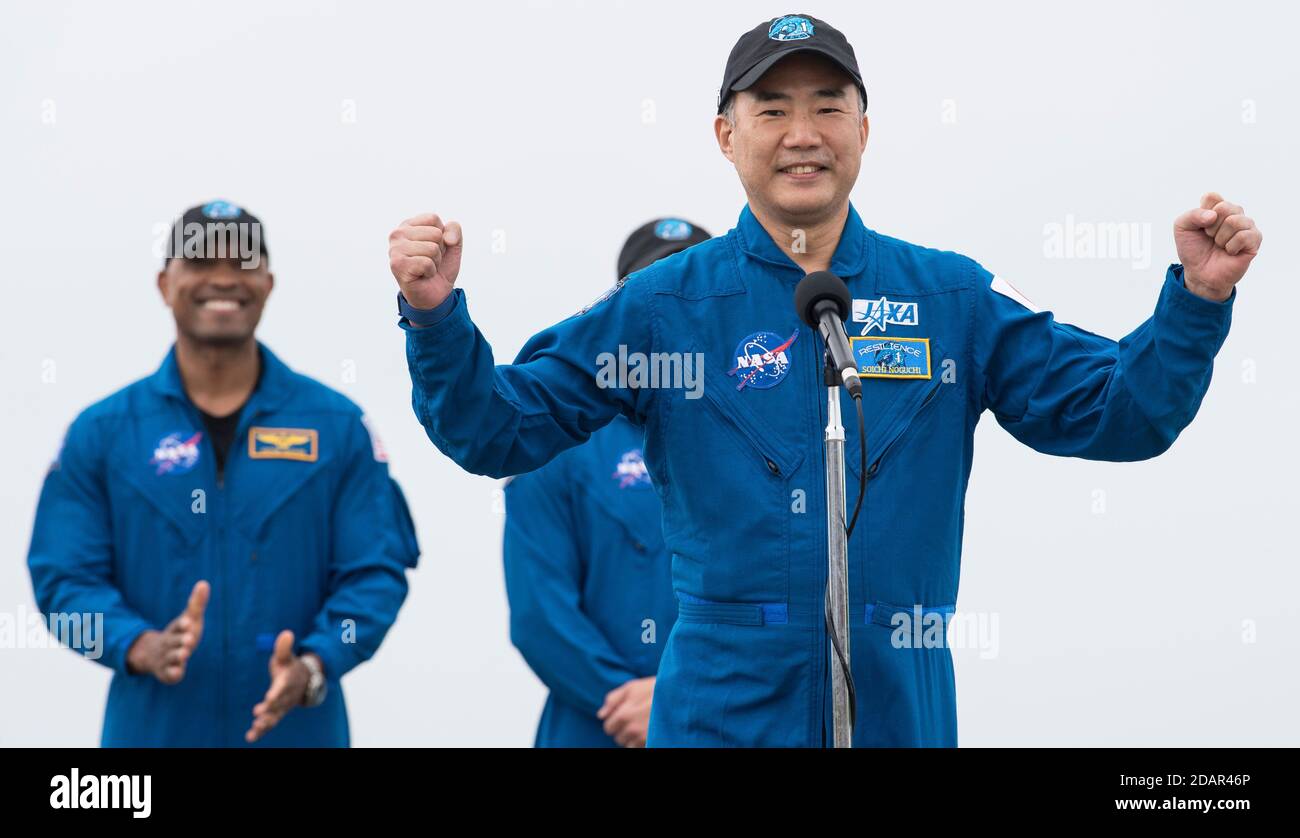 JAXA astronaut Soichi Noguchi speaks to the media after arriving at the Launch and Landing Facility for the Commercial Crew One mission at the Kennedy Space Center November 8, 2020 in Cape Canaveral, Florida. Standing behind Noguchi are: NASA astronauts Victor Glover and Mike Hopkins. Stock Photo