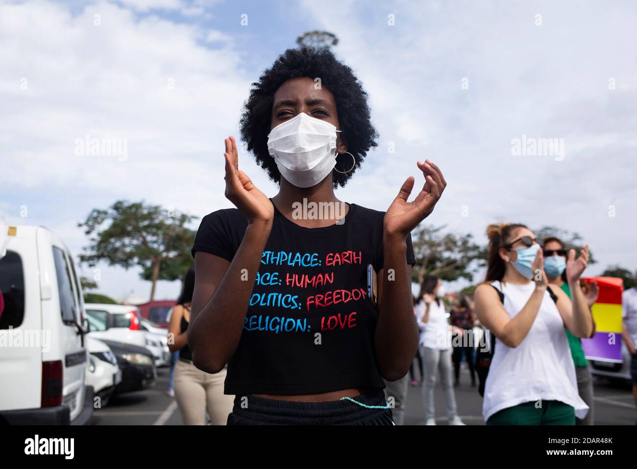 San Bartolome De Tirajana, Spain. 14th Nov, 2020. A participant of the autocorso for the rights of migrants applauds. People demonstrated for the rights of migrants in Gran Canaria with a motorcade through several places on the island. Credit: Manuel Navarro/dpa/Alamy Live News Stock Photo