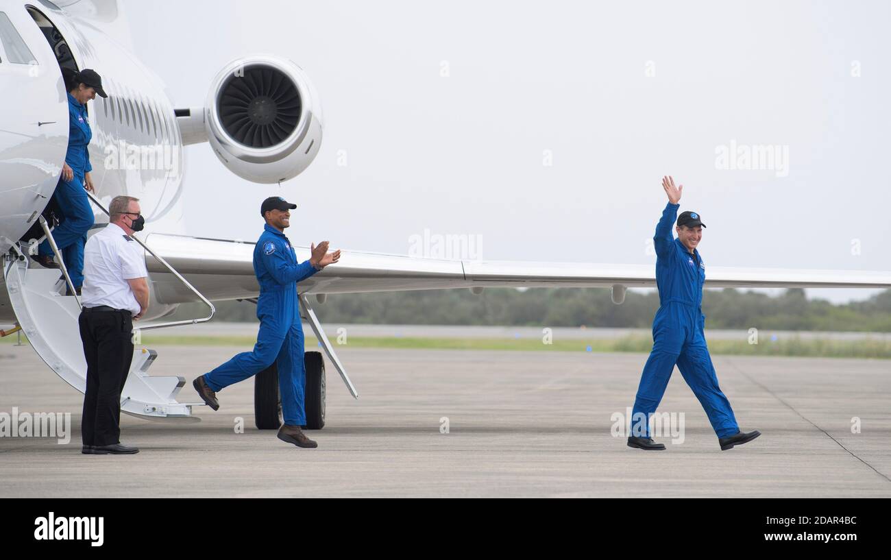 NASA astronauts Mike Hopkins, right, Victor Glover, center, and Shannon Walker, left, wave as they arrive at the Launch and Landing Facility for the Commercial Crew One mission at the Kennedy Space Center November 8, 2020 in Cape Canaveral, Florida. Stock Photo