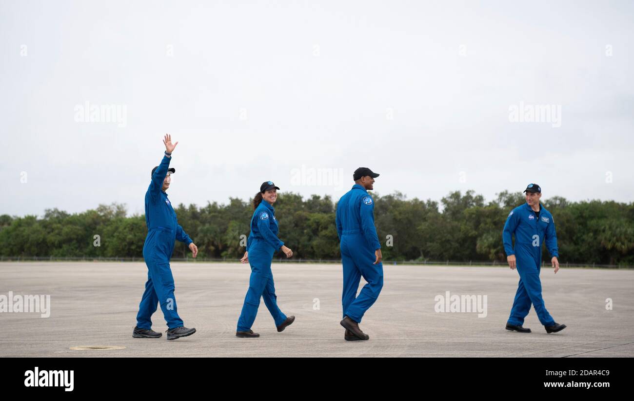 NASA astronauts wave as they depart the Launch and Landing Facility for the Commercial Crew One mission at the Kennedy Space Center November 8, 2020 in Cape Canaveral, Florida. Standing from left to right are: JAXA astronaut Soichi Noguchi, NASA astronauts Shannon Walker, Victor Glover and Mike Hopkins. Stock Photo