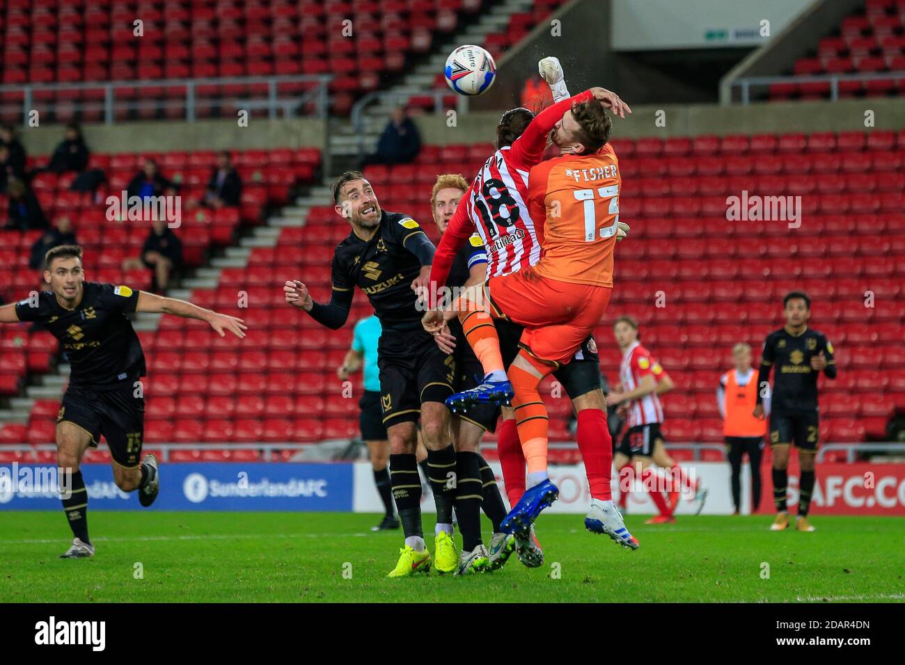 Andy Fisher #13 of Milton Keynes Dons punches the ball under pressure from Danny Graham #18 of Sunderland Stock Photo