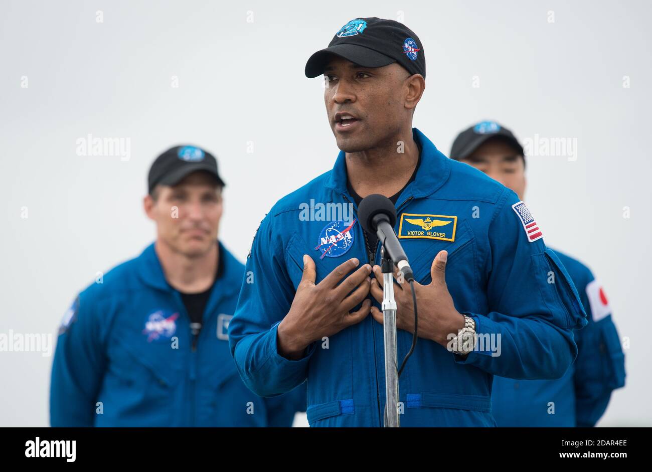 NASA astronaut Victor Glover speaks to the media after arriving at the Launch and Landing Facility for the Commercial Crew One mission at the Kennedy Space Center November 8, 2020 in Cape Canaveral, Florida. Standing behind Glover are: NASA astronaut Mike Hopkins and JAXA astronaut Soichi Noguchi, right. Stock Photo