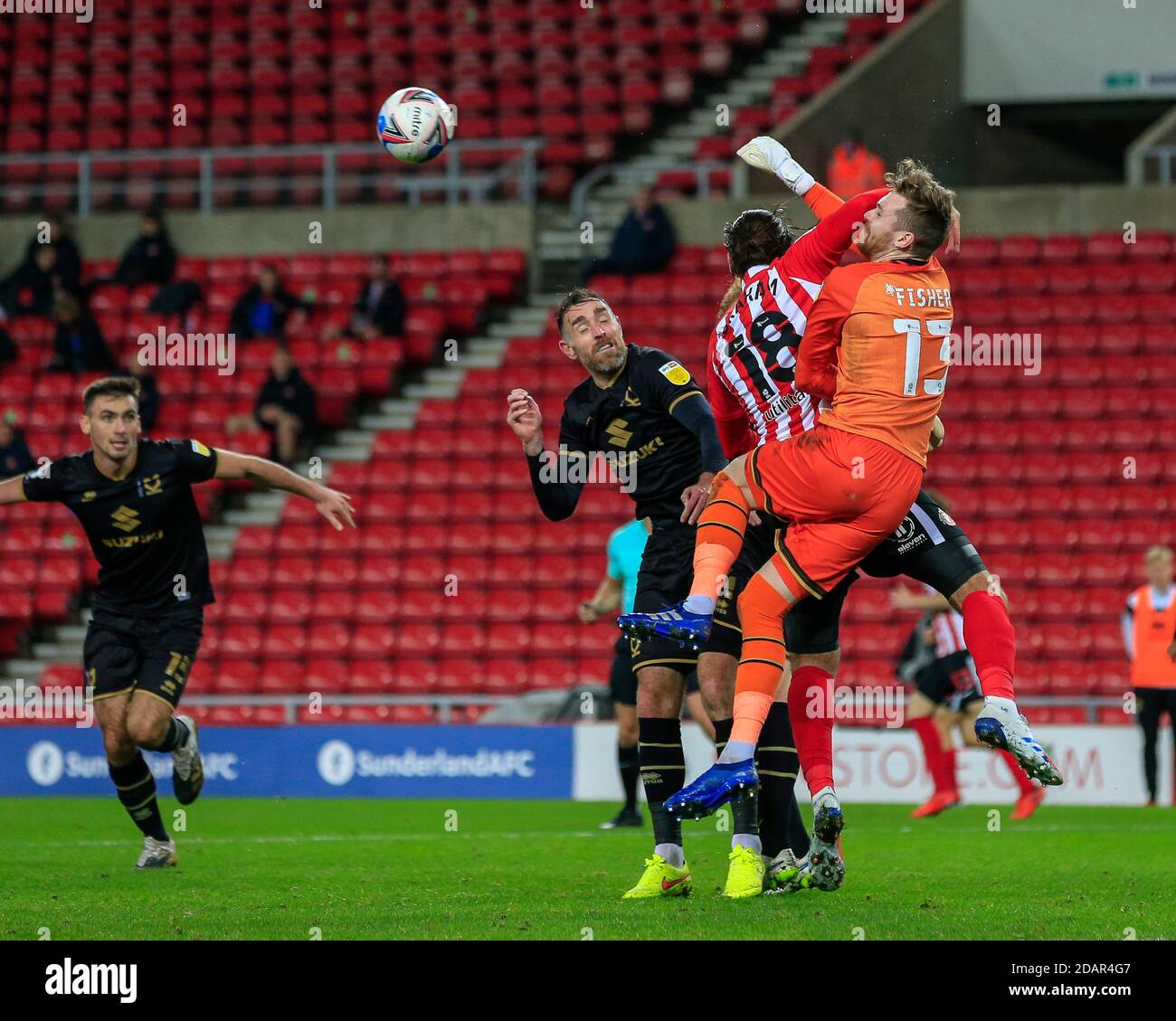 Andy Fisher #13 of Milton Keynes Dons punches the ball under pressure from Danny Graham #18 of Sunderland Stock Photo