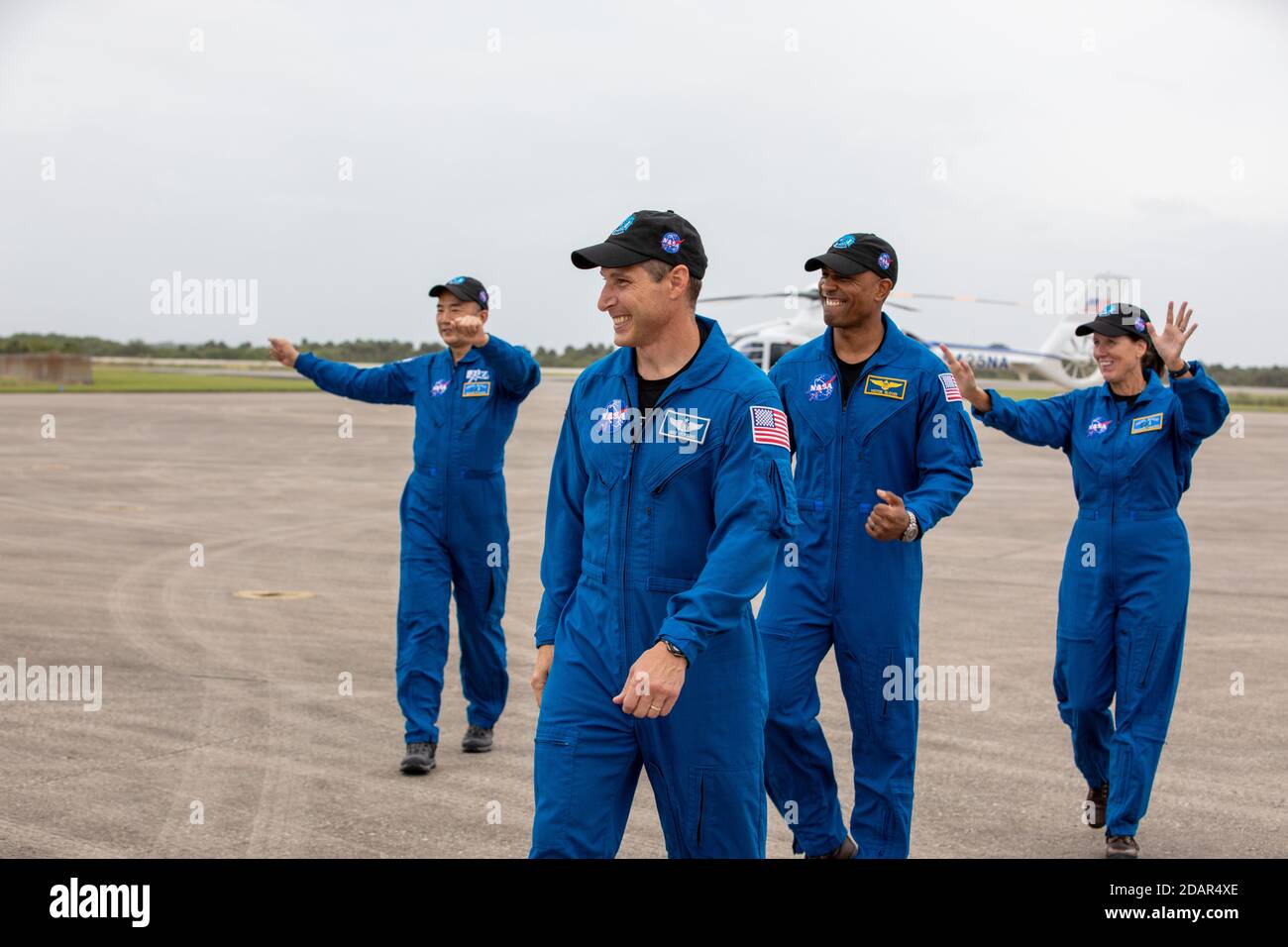 NASA astronauts wave as they arrive at the Launch and Landing Facility for the Commercial Crew One mission at the Kennedy Space Center November 8, 2020 in Cape Canaveral, Florida. Standing from left to right are: JAXA astronaut Soichi Noguchi, NASA astronaut Mike Hopkins, Victor Glover and Shannon Walker. Stock Photo