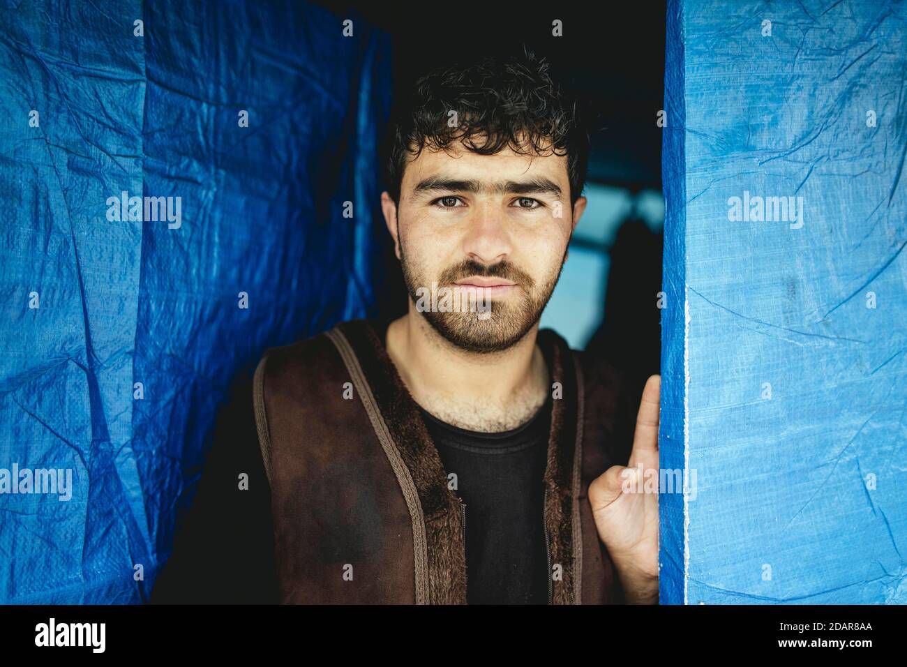 Sami, 20, Afghanistan, in camp for three months, shares hut with cousin and companions he met on the run, Moria, Lesbos, Greece Stock Photo