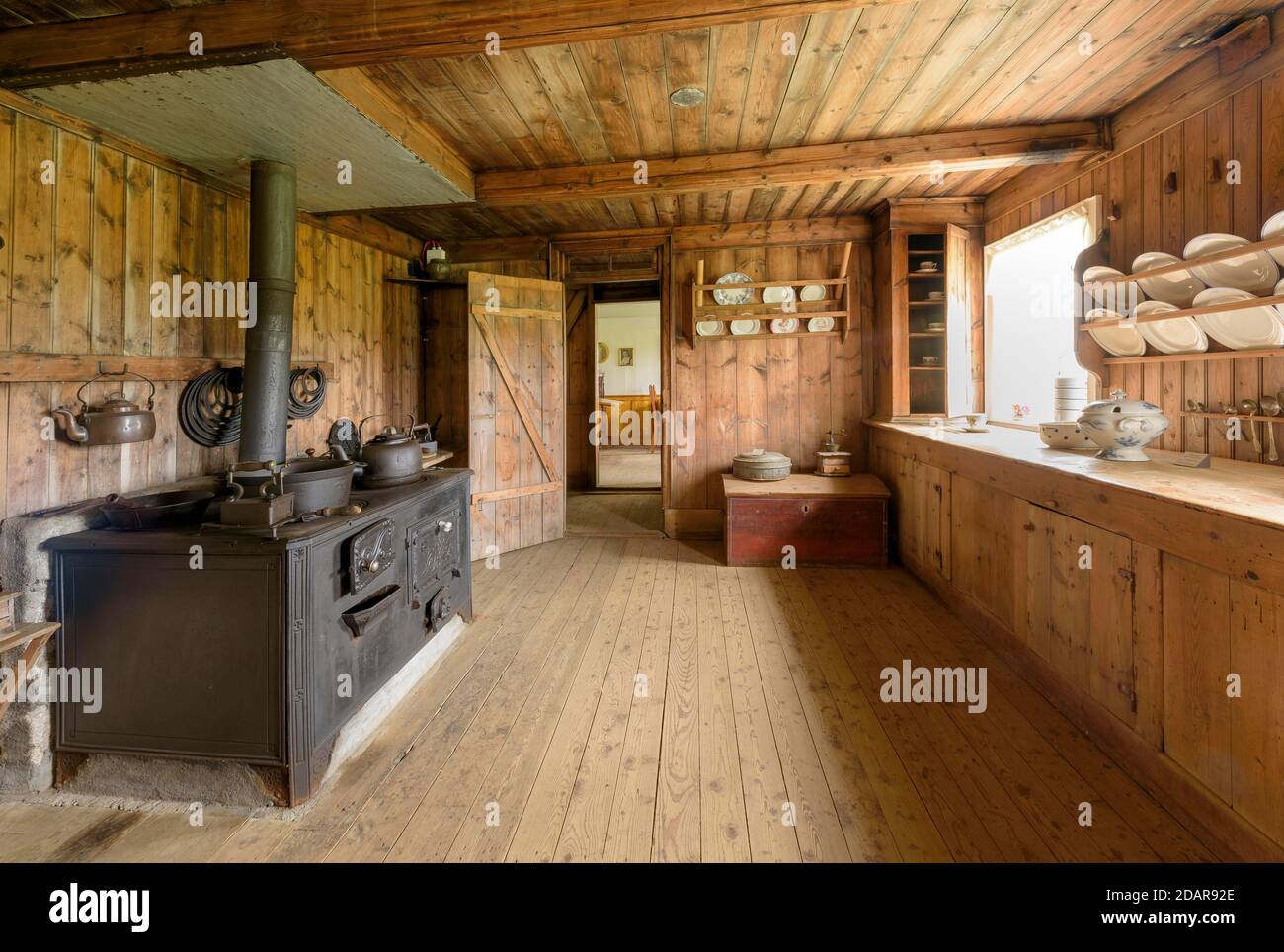 Interior view of historical kitchen with old oven, pans, pots, tea maker and old porcelain on peatyard, sod house settlement Grenjadarstadur Stock Photo