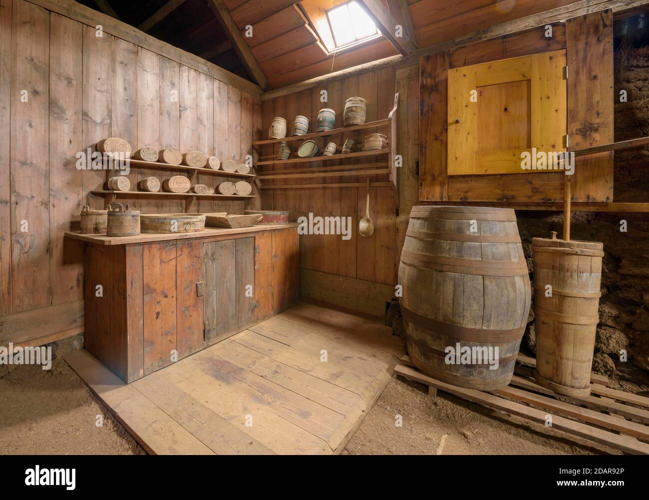 Interior view of a butter production with butter barrel, butter tub, butter moulds on the wall on a peat farm, sod house settlement Grenjadarstadur Stock Photo