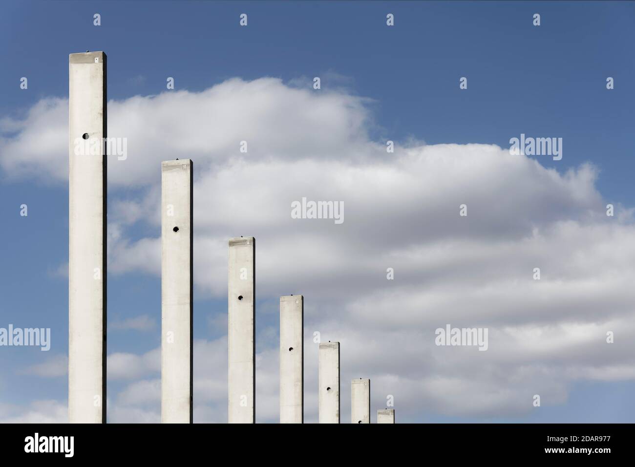 Concrete columns in a row, in front of a blue sky, carcass logistics hall, Duisburg, North Rhine-Westphalia, Germany Stock Photo