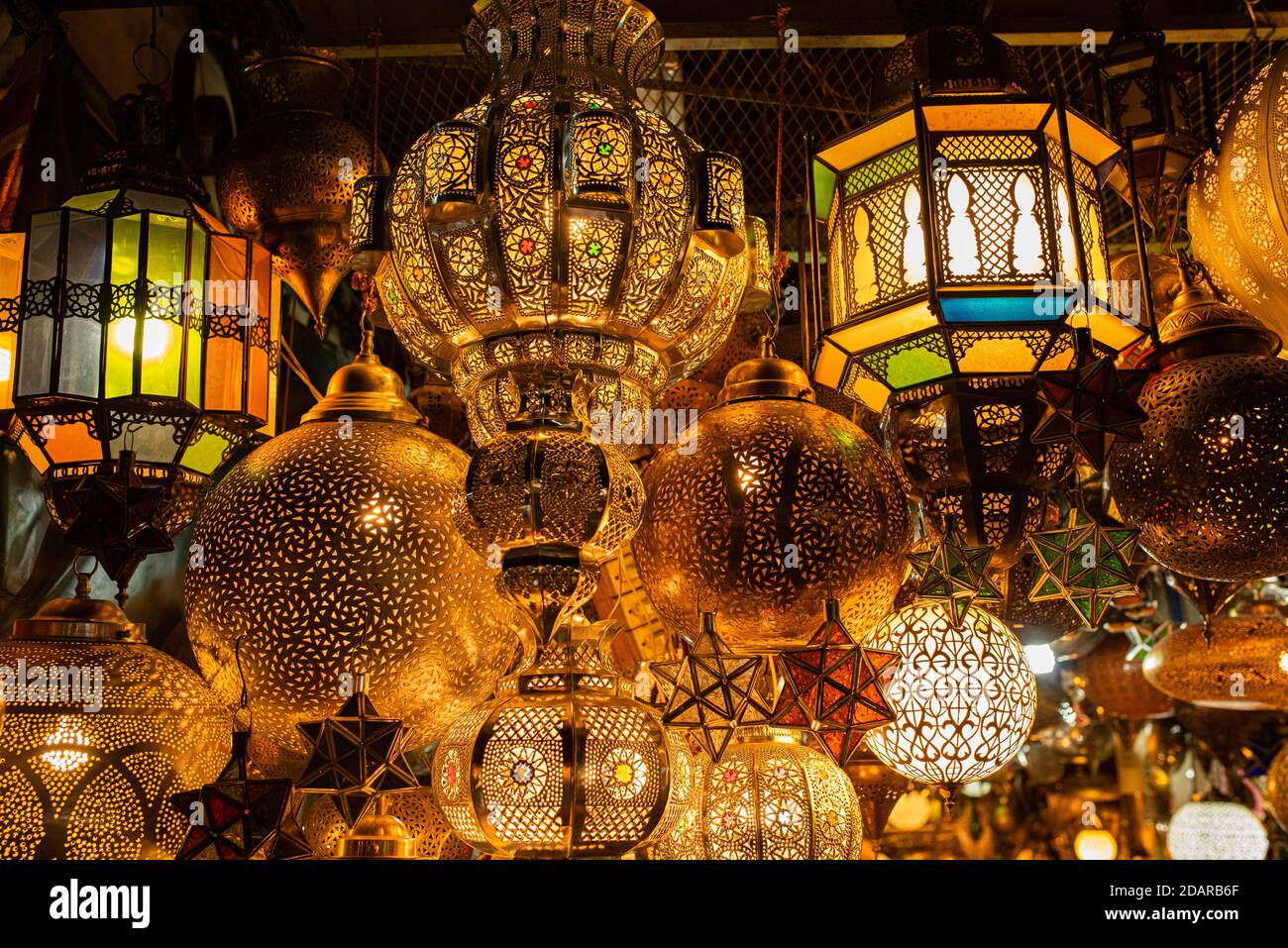 Various lamps made of brass or copper and colored glass for sale hung up, souk, bazaar, Marrakech, Morocco Stock Photo