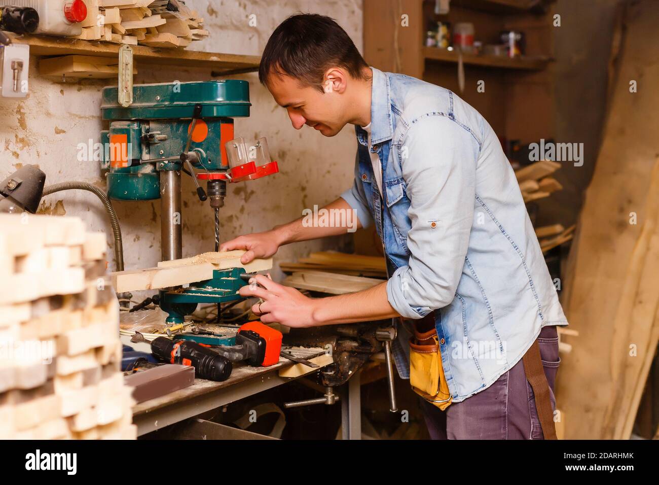Carpenter works in a workshop for the production of vintage furniture Stock Photo