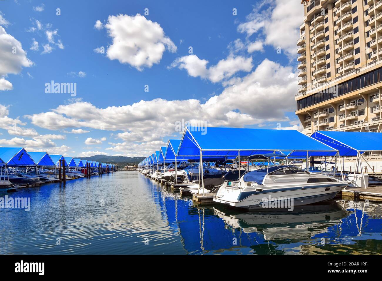 Boats in their covered slips in the marina and boardwalk of a downtown