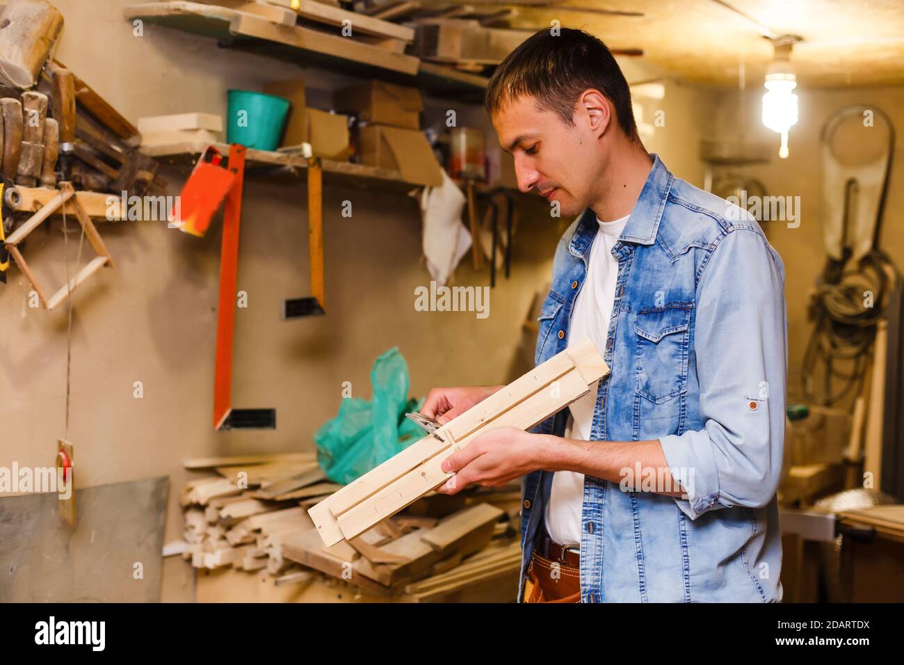 Carpenter works in a workshop for the production of vintage furniture Stock Photo