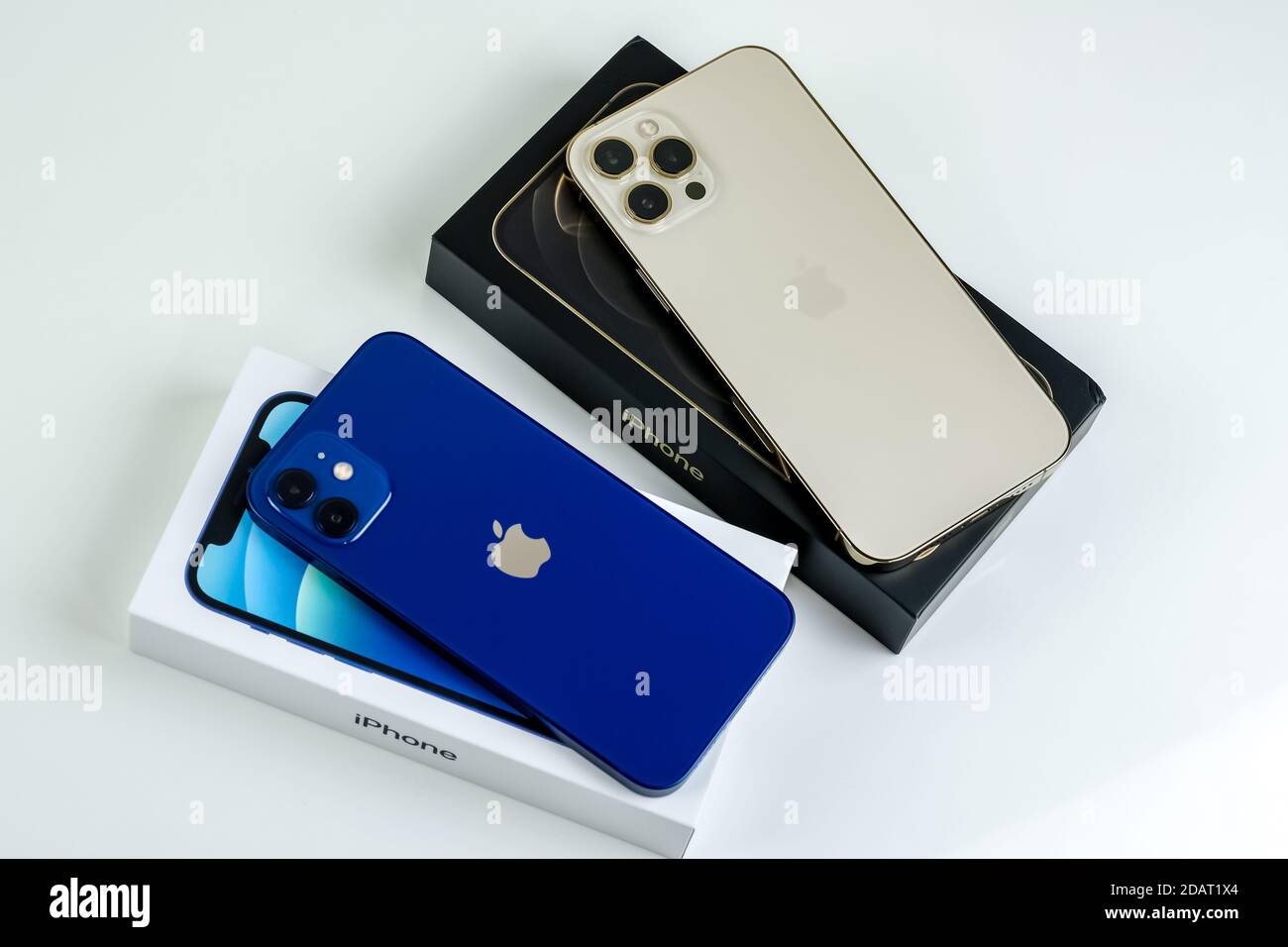 Iphone 12 Pro Max In Gold Next To Iphone 12 In Blue Stock Photo Alamy