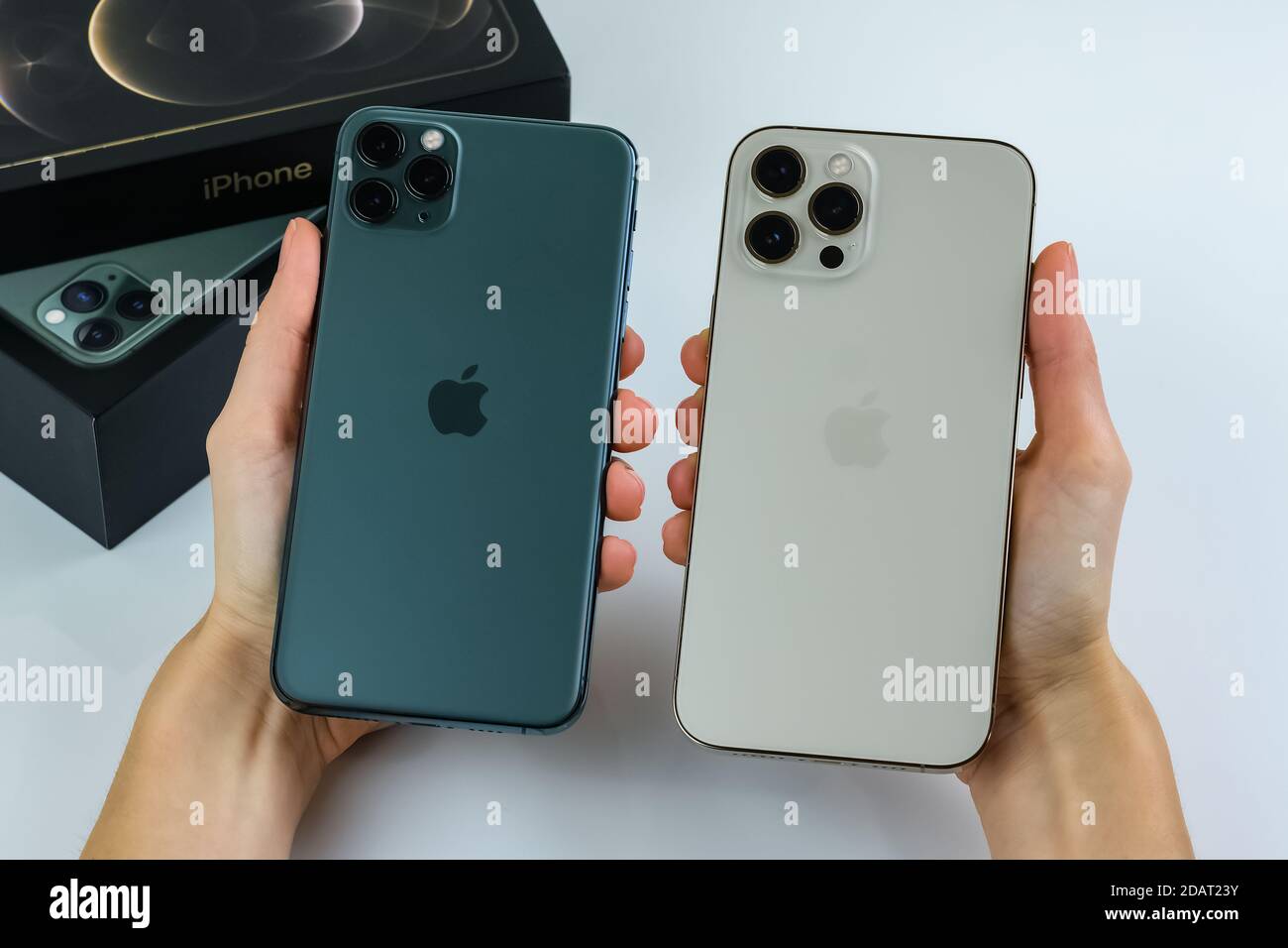Phone 12 Pro Max In Gold Next To Iphone 11 Pro Max In Midnight Green Color Stock Photo Alamy