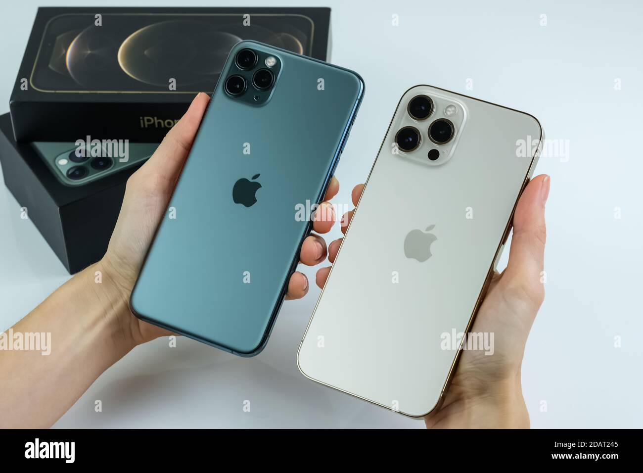 Phone 12 Pro Max in Gold next to iPhone 11 Pro Max in Midnight
