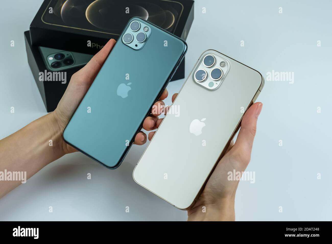 Phone 12 Pro Max In Gold Next To Iphone 11 Pro Max In Midnight Green Color Stock Photo Alamy