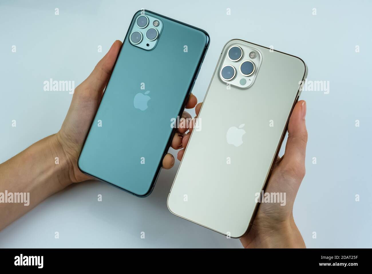 Phone 12 Pro Max In Gold Next To Iphone 11 Pro Max In Midnight Green Color Stock Photo Alamy