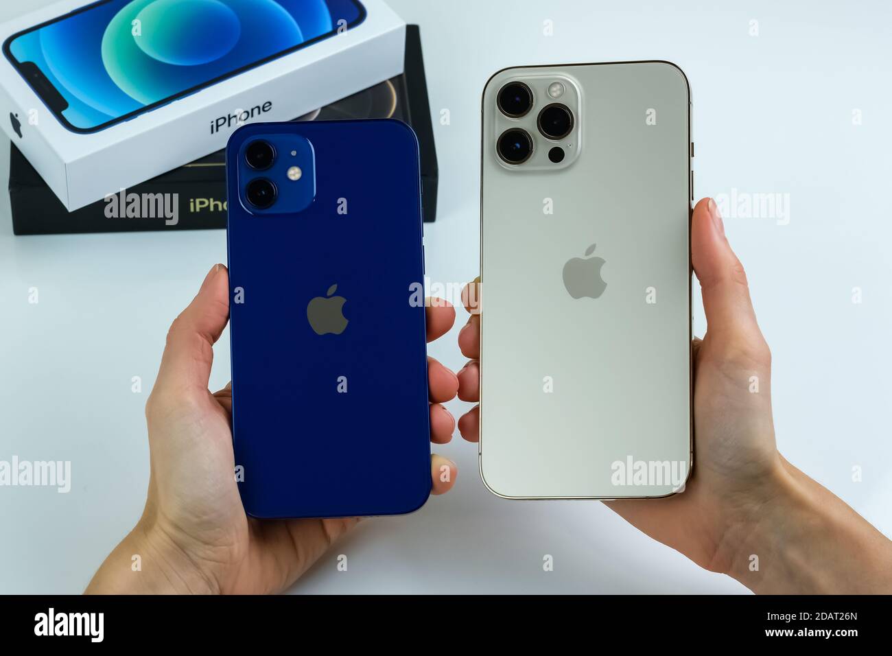 Iphone 12 Pro Max In Gold Next To Iphone 12 In Blue Stock Photo Alamy