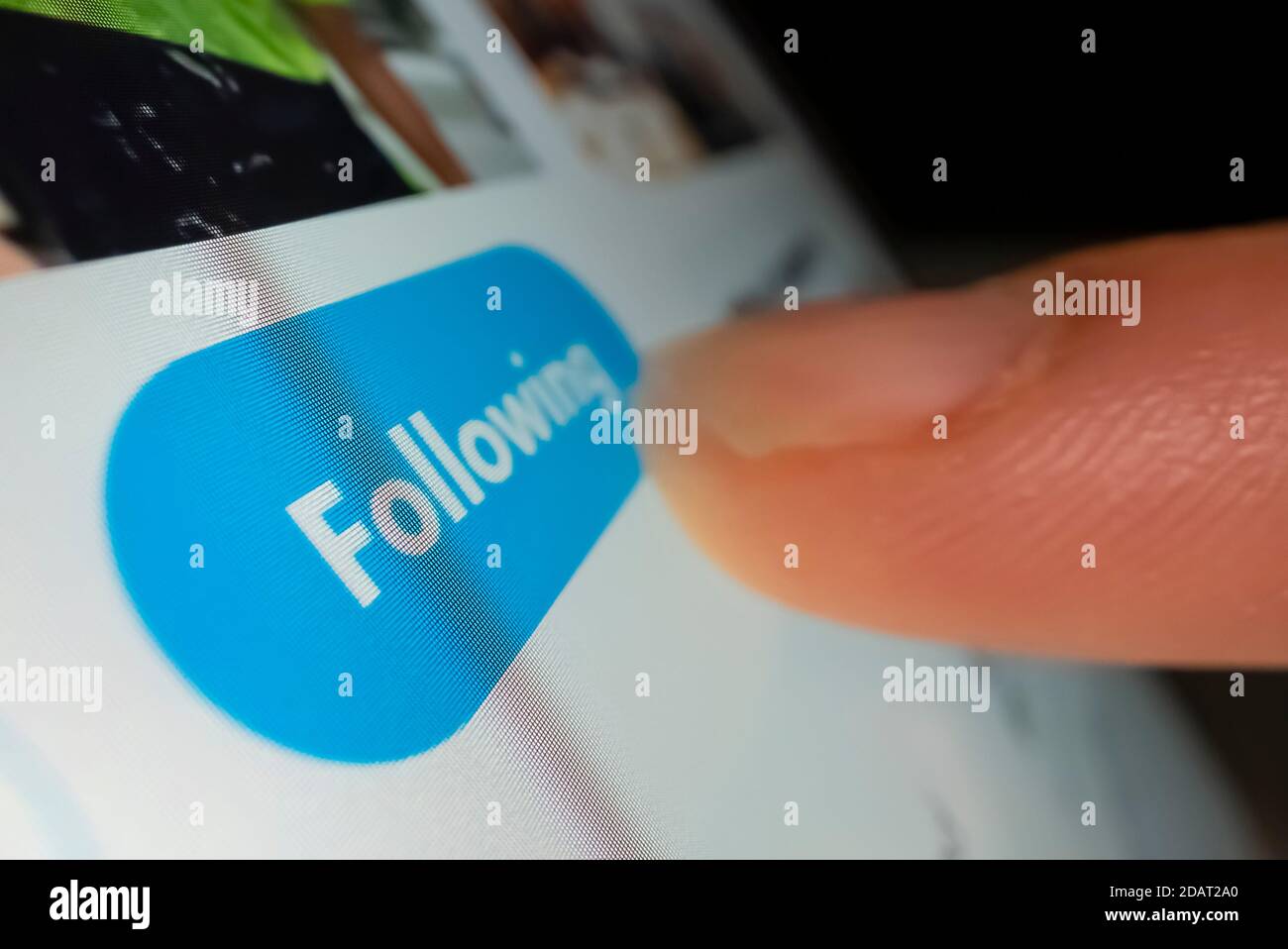 Macro shot of clicking the follow button in Twitter Stock Photo