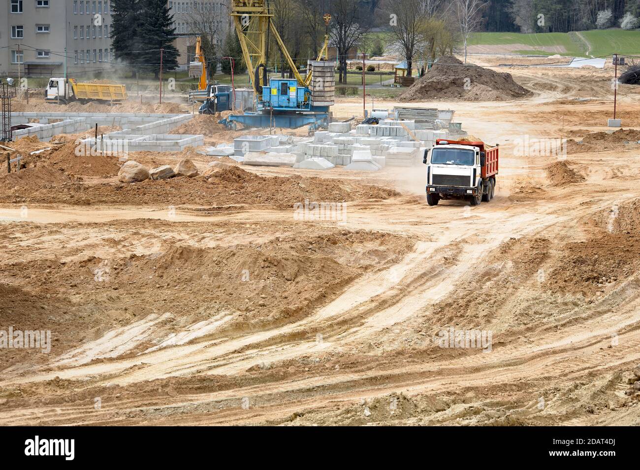 Multi-ton heavy mining dump truck loaded with cargo during removal of construction soil from construction site. Concept of providing transport Stock Photo