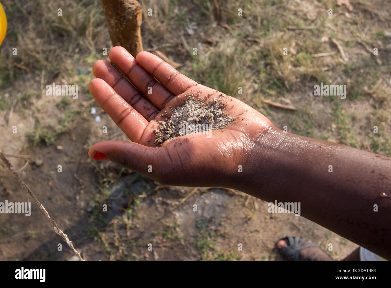 Hand washing with ash as an alternative to soap. WHO guidelines currently recommend that ash can be used for hand cleaning when soap is not available Stock Photo