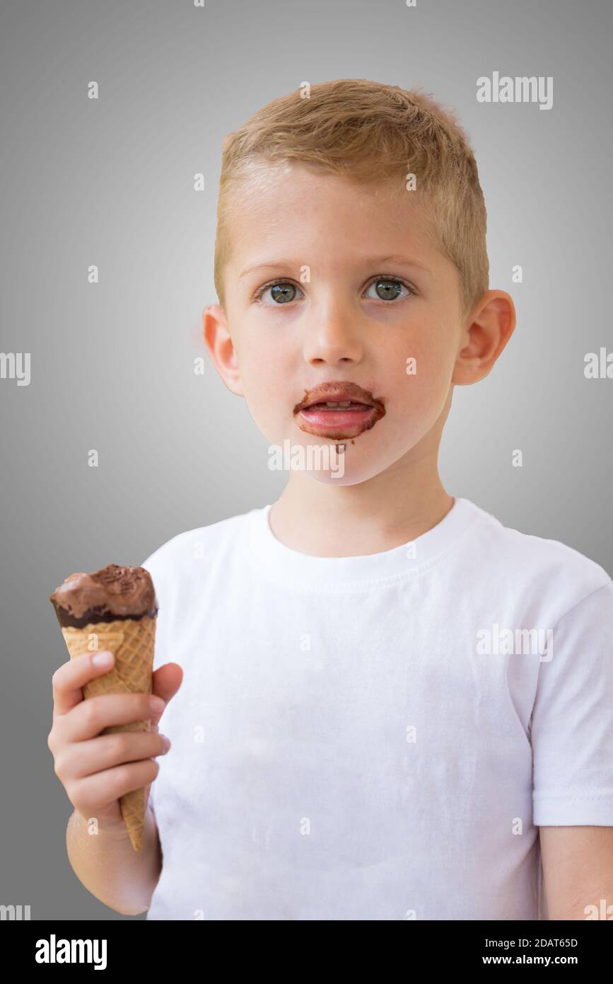 Baby boy kid hold chocolate ice cream in waffles cone isolated on gray background with free text