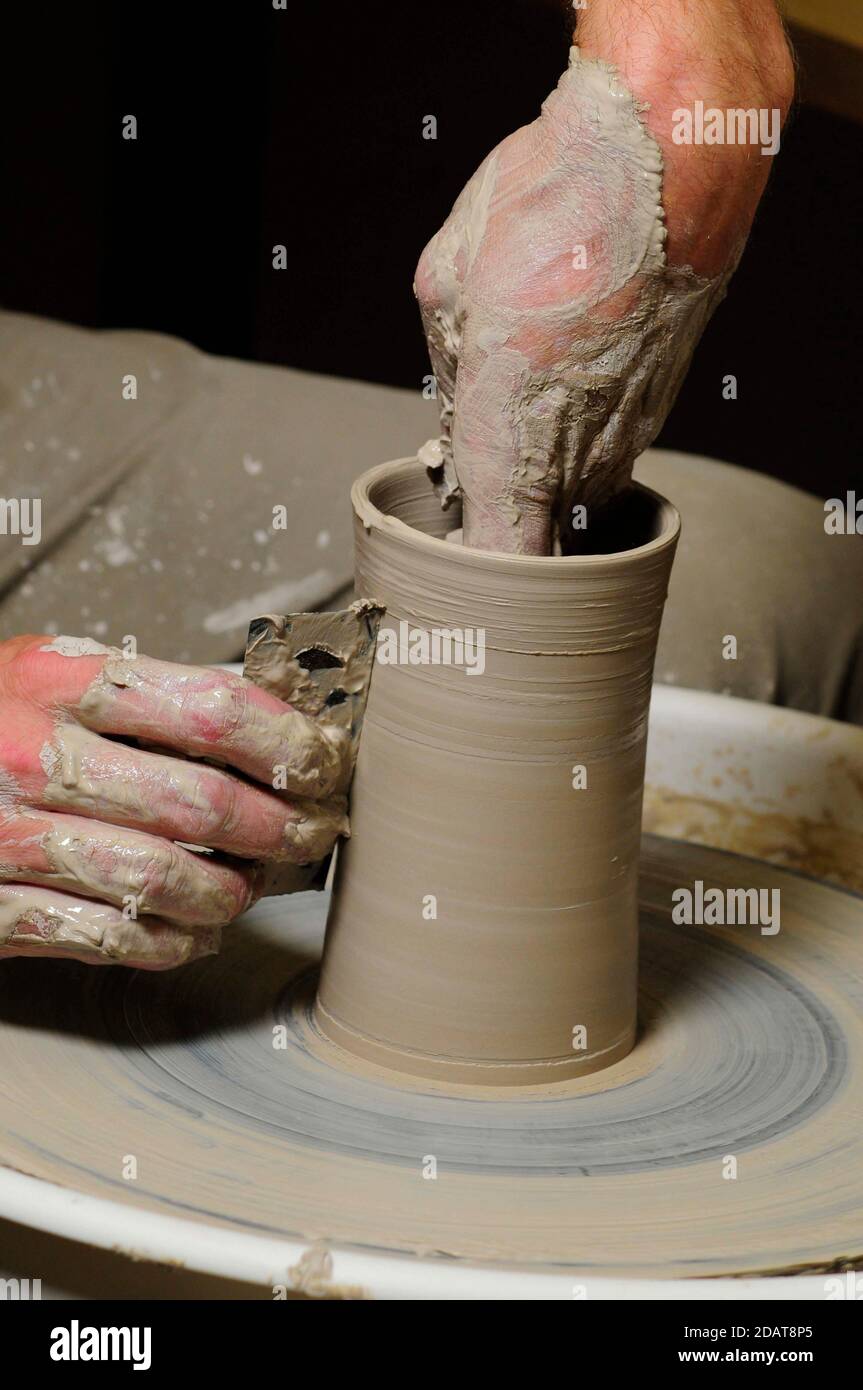 man making pottery with his hand on a pottery wheel Stock Photo - Alamy