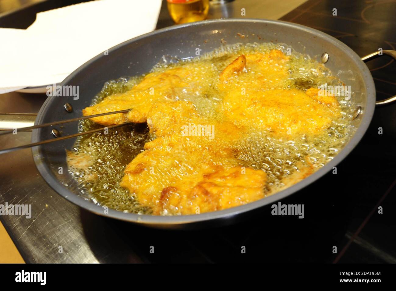 deep frying a wiener schnitzel in a pan with oil Stock Photo Alamy