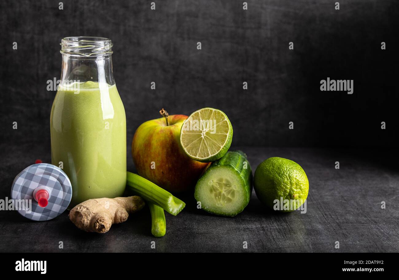Homemade smoothie with the following detox ingredients ginger, cucumber, apple and lemon. Stock Photo
