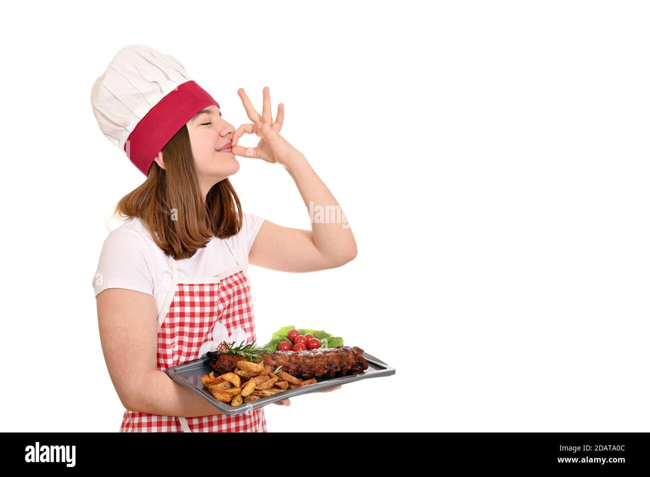 happy girl cook with pork ribs at plate and ok hand sign Stock Photo